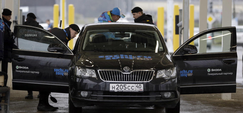 Russian police officers search a vehicle at an entrance to the Sochi 2014 Olympic Winter Games park, Thursday, Jan. 23, 2014, in Sochi, Russia. The Olympics begin on Feb. 7. (AP Photo/David J. Phillip)