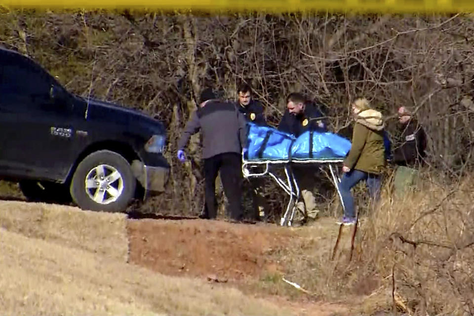 In this undated image made from a video by KWTV-DT, rescue crew recover a body near Lake Overholser in Oklahoma City, Okla. Authorities are trying to determine whether three bodies that have been discovered in or near an Oklahoma City-area lake in less than two weeks are connected. The body of 18-year-old Kelvin Perez-Lopez was pulled from Lake Overholser on Feb. 23. 2019. On March 2, the body of a teen or young adult was discovered along the lake's southernmost edge. That body has not been identified. The third body was discovered Tuesday in a wooded area near the lake. (KWTV-DT via AP)