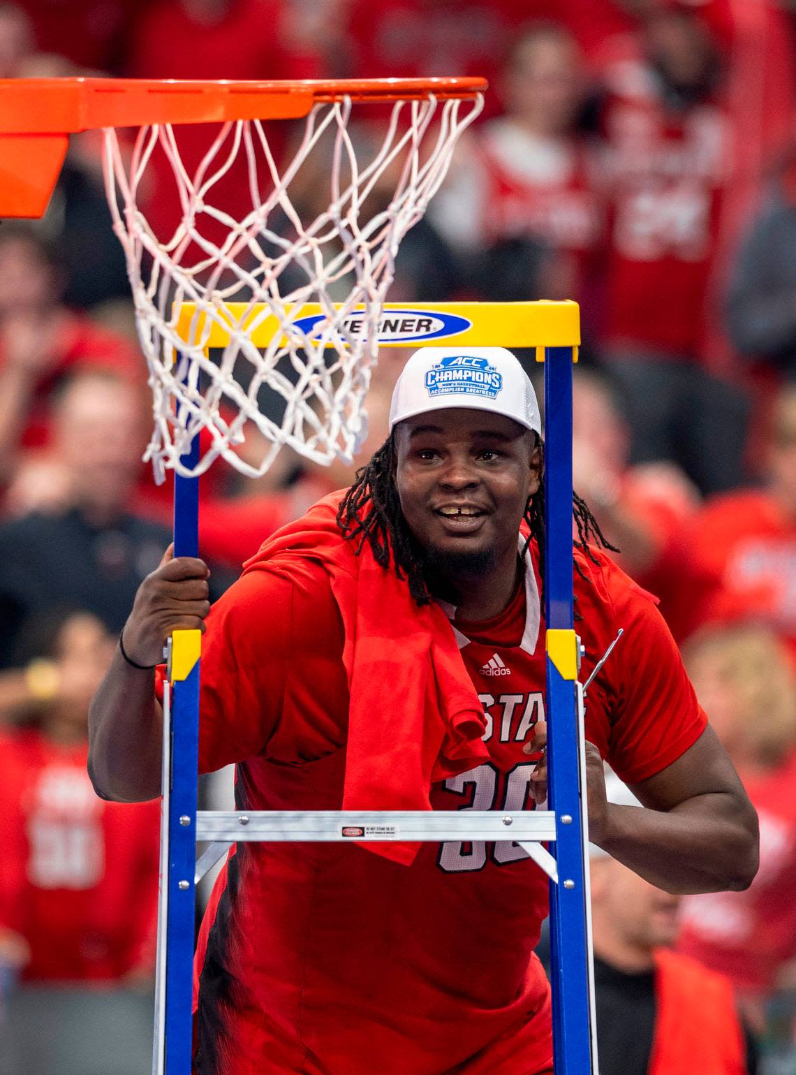 ACC Tournament MVP, N.C. State’s D.J. Burns Jr. (30) climbs the ladder to cut down the net following the Wolfpack’s 84-76 victory over North Carolina at the ACC Men’s Basketball Tournament Championship at Capitol One Arena on Saturday, March 16, 2024 in Washington, D.C.