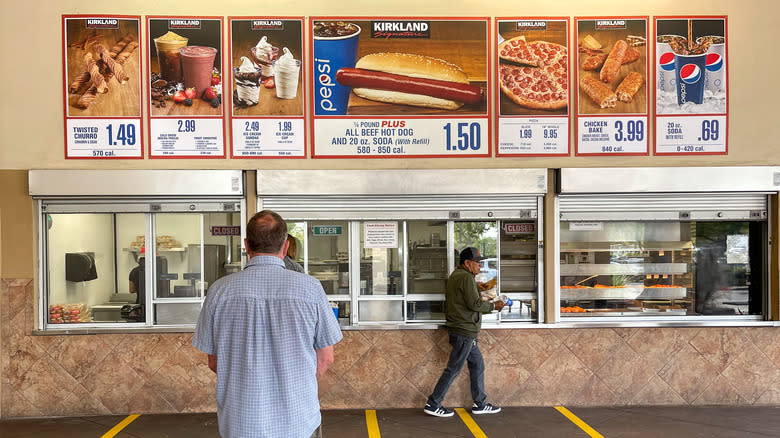 man standing outside food court 