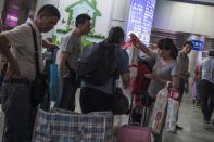People resell goods at the border to Hong Kong at Luohu (known as Lo Wu in Hong Kong) station in Shenzhen on April 24, 2015