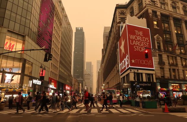 Heavy smoke fills the air as people cross 34th Street in Herald Square on Tuesday in New York City. 