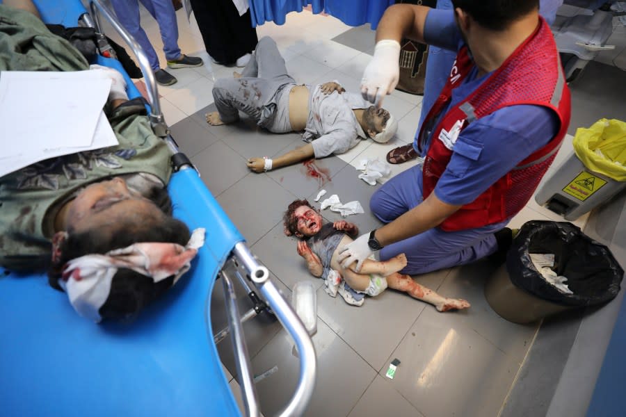 Palestinians wounded in Israeli strikes are brought to Shifa Hospital in Gaza City on Wednesday, Oct. 11, 2023. (AP Photo/Ali Mahmoud)