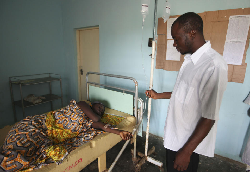 FILE - In this Monday, Sept. 6, 2010 file photo, a doctor treats a person suffering from cholera, at a village health clinic in Ganjuwa in Nigeria's rural Bauchi State. Nigeria is seeing one of its worst cholera outbreaks in years, with more than 2,300 people dying from suspected cases as the West African nation struggles to deal with multiple disease outbreaks. The 2021 outbreak which is associated with a higher case fatality rate than the previous four years is also worsened by what many consider to be a bigger priority for state governments: the COVID-19 pandemic. (AP Photo/Sunday Alamba, File)