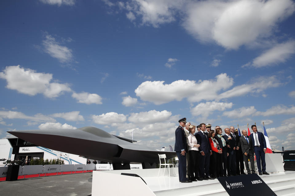 French President Emmanuel Macron, Eric Trappier, Chairman and CEO of Dassault Aviation, Dirk Hoke, CEO of Airbus Defense and Space, Spanish Defense Minister Margarita Robles, German Defense Minister Ursula von der Leyen and French Defense Minister Florence Parly attend the unveiling of the French-German-Spanish New Generation Fighter (NGF) model during a visit at Le Bourget Airport near Paris, France, Monday June 17, 2019. The world's aviation elite are gathering at the Paris Air Show with safety concerns on many minds after two crashes of the popular Boeing 737 Max. (Benoit Tessier/Pool via AP)