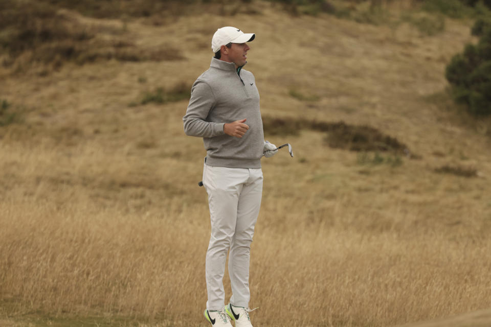 Rory McIlroy of Northern Ireland jumps to check the line on the 12th hole during the third round of the British Open golf championship on the Old Course at St. Andrews, Scotland, Saturday July 16, 2022. (AP Photo/Peter Morrison)