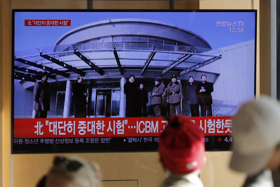 People watch a TV news program reporting North Korea's announcement with a file footage of North Korean leader Kim Jong Un, at the Seoul Railway Station in Seoul, South Korea, Sunday, Dec. 8, 2019. North Korea said Sunday it carried out a “very important test” at its long-range rocket launch site that U.S. and South Korean officials said the North had partially dismantled as part of denuclearization steps. The letters read "North. Very important test." (AP Photo/Lee Jin-man)