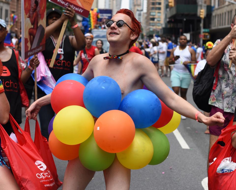 <p>People take part in the annual 2018 New York City Pride Parade on June 24, 2018 as they make their way down 7th Avenue in New York. (Photo: Timothy A. Clary/AFP/Getty Images) </p>