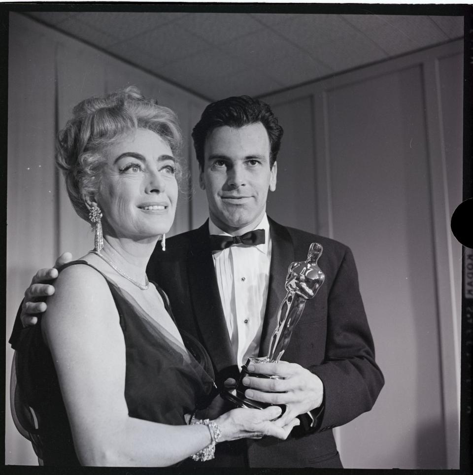 <p>Here, Joan Crawford presents Austrian-Swiss actor Maximillian Schell the Oscar for Best Actor for <em>The Judgement at </em><em>Nuremberg</em>. The film was a fictionalized version of one of the Nuremberg War Trials, and Schell played defense attorney Hans Rolfe. Schell himself was a refugee of Nazi Germany, having to flee from Austria and resettle in Switzerland when it was annexed in 1938. </p>