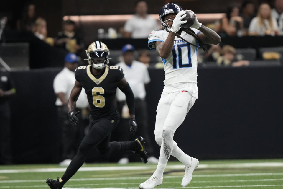 Tennessee Titans wide receiver DeAndre Hopkins (10) makes a catch in front of New Orleans Saints safety Marcus Maye (6) in the first half of an NFL football game in New Orleans, Sunday, Sept. 10, 2023. (AP Photo/Gerald Herbert)