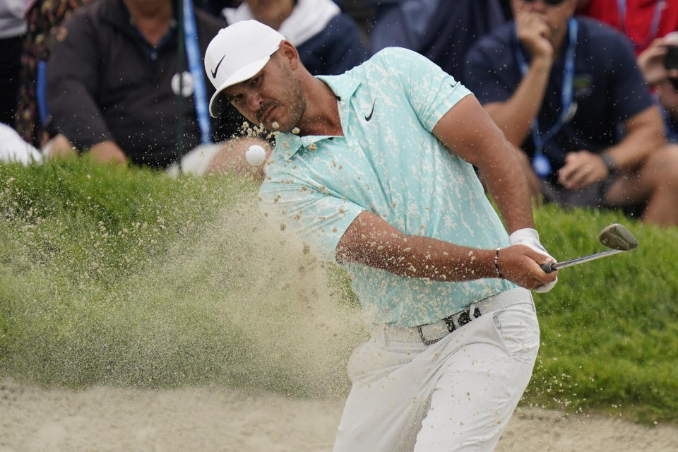 Brooks Koepka plays a shot from a bunker on the 18th hole during the final round of the U.S. Open Golf Championship, Sunday, June 20, 2021, at Torrey Pines Golf Course in San Diego. (AP Photo/Gregory Bull)