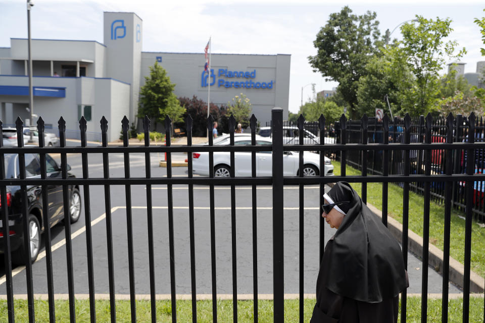 Sister Benedicta, a Carmelite nun, stands at a gate outside the Planned Parenthood clinic in St. Louis during an anti-abortion rally Tuesday, June 4, 2019. A judge is considering whether the clinic, Missouri's only abortion provider, can remain open. (AP Photo/Jeff Roberson)