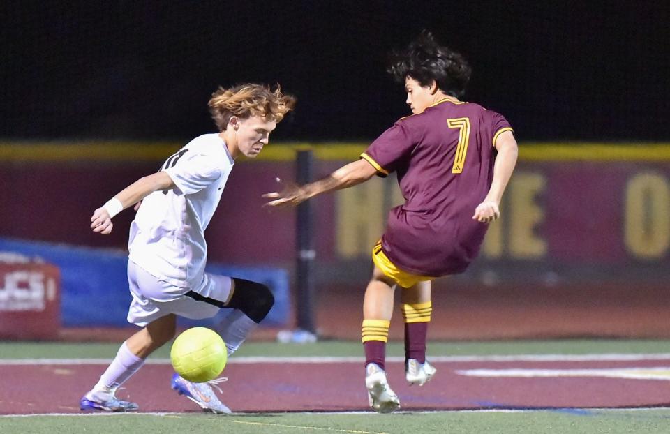Oak Park's Zach Harris tries to slip past a Simi Valley defender during the Eagles' 4-1 win on the road Wednesday night. Harris scored all four goals as Oak Park finished the regular season at 16-1 and as unbeaten Coastal Canyon League champions at 8-0.