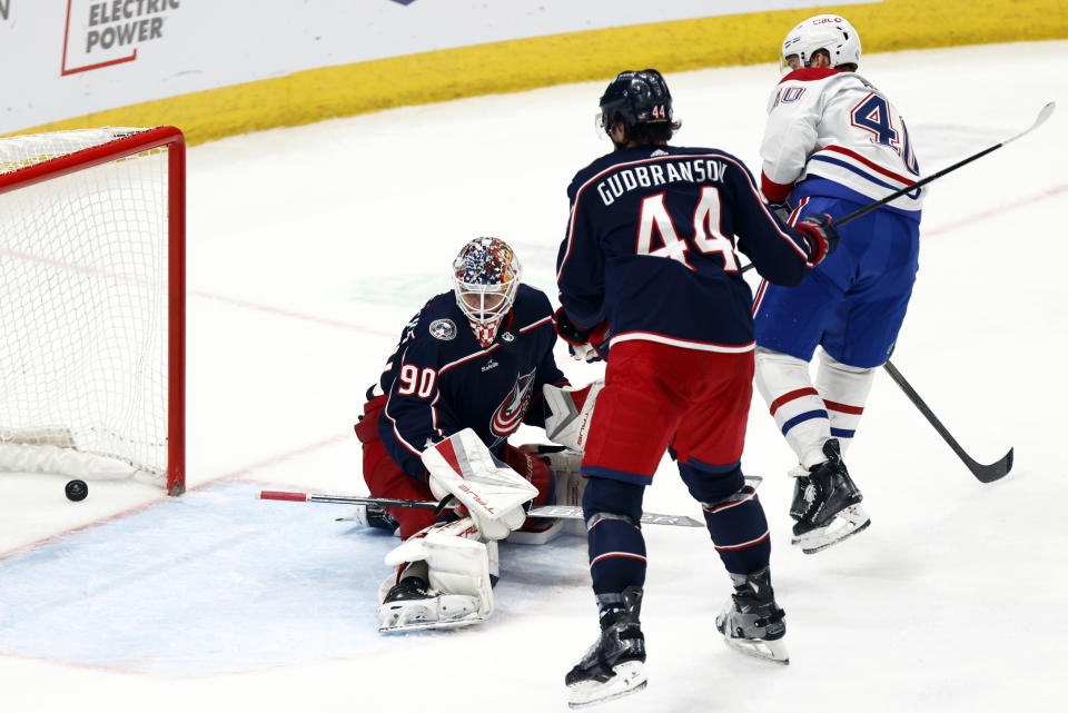 Montreal Canadiens foward Joel Armia, right, scores a goal past Columbus Blue Jackets goalie Elvis Merzlikins, left, and defenseman Erik Gudbranson during the third period of an NHL hockey game in Columbus, Ohio, Wednesday, Nov. 29, 2023. The Canadiens won 4-2. (AP Photo/Paul Vernon)