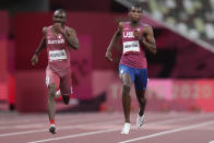 FILE - Erriyon Knighton, right, of the United States, and Femi Ogunode, of Qatar, race to the finish line in a semifinal of the men's 200-meters at the 2020 Summer Olympics, Tuesday, Aug. 3, 2021, in Tokyo. (AP Photo/Petr David Josek, File)