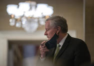 White House chief of staff Mark Meadows, removes his face mask to speak to media as he arrives at House Speaker Nancy Pelosi's office on Capitol Hill in Washington, Thursday, Aug. 6, 2020. (AP Photo/Carolyn Kaster)