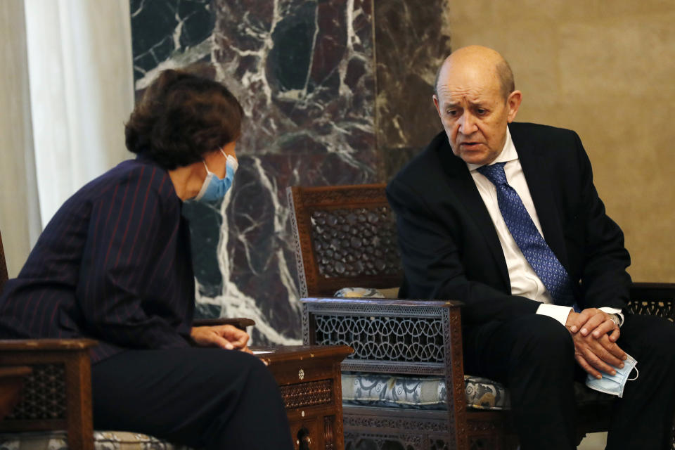 French Foreign Minister Jean-Yves Le Drian, right, speaks with the French Ambassador to Lebanon Anne Grillo, left, during his meeting with Lebanese President Michel Aoun at the Presidential Palace in Baabda, east of Beirut, Lebanon, Thursday, May 6, 2021. Le Drian is in Beirut for two days visit to meet with Lebanese officials. (AP Photo/Hussein Malla)