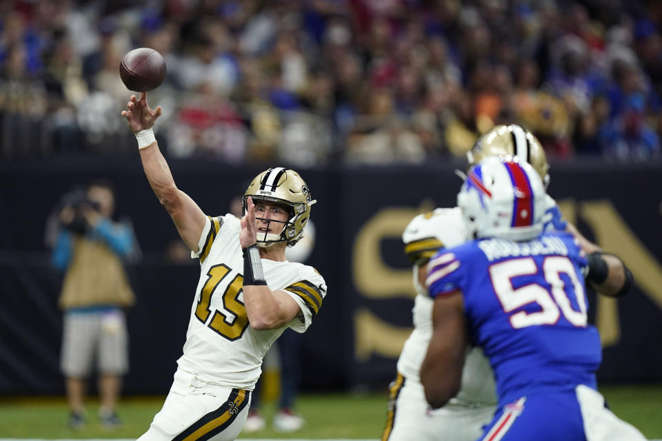 New Orleans Saints quarterback Trevor Siemian (15) passes under pressure from Buffalo Bills defensive end Greg Rousseau (50) in the first half of an NFL football game in New Orleans, Thursday, Nov. 25, 2021. (AP Photo/Derick Hingle)
