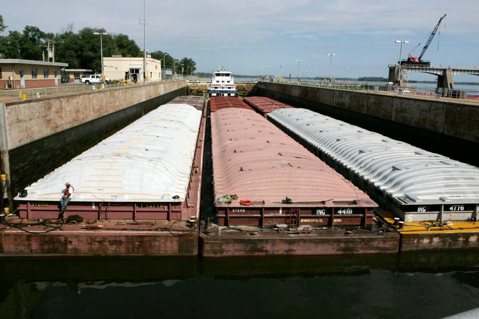 A towboat and its barges are shown in the channel at Lock and Dam 25 at Winfield, Missouri. The U.S. Army Corps will spend $732 million to expand the congested lock and dam in Missouri.