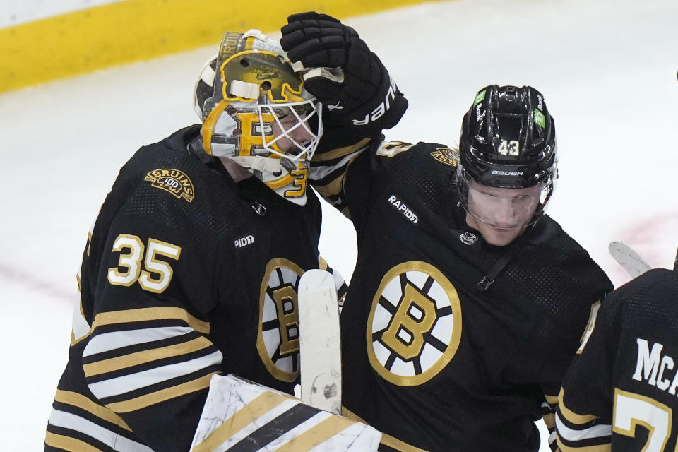 Boston Bruins goaltender Linus Ullmark (35) celebrates with left wing Danton Heinen (43) after the Bruins defeated the Vancouver Canucks in an NHL hockey game Thursday, Feb. 8, 2024, in Boston. (AP Photo/Steven Senne)