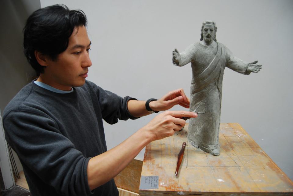 Blue Ash sculptor Tom Tsuchiya works on a representation of Jesus that served as the model for a statue at Solid Rock Church in Monroe.