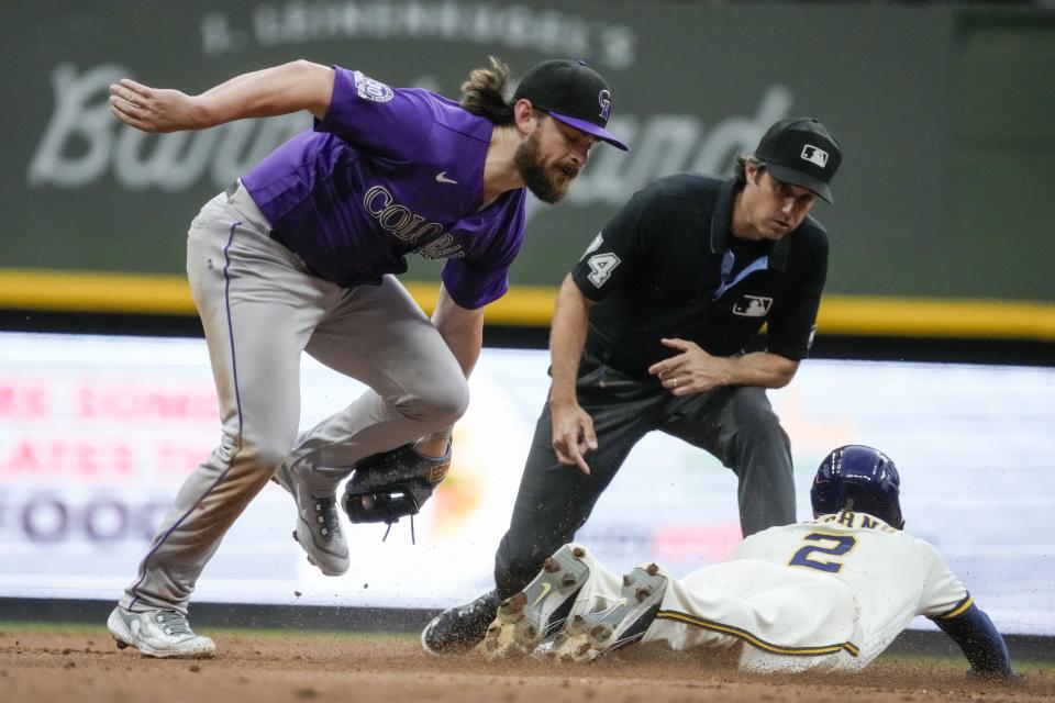 Milwaukee Brewers' Brice Turang steals second with Colorado Rockies' Brendan Rodgers covering during the second inning of a baseball game Monday, Aug. 7, 2023, in Milwaukee. (AP Photo/Morry Gash)