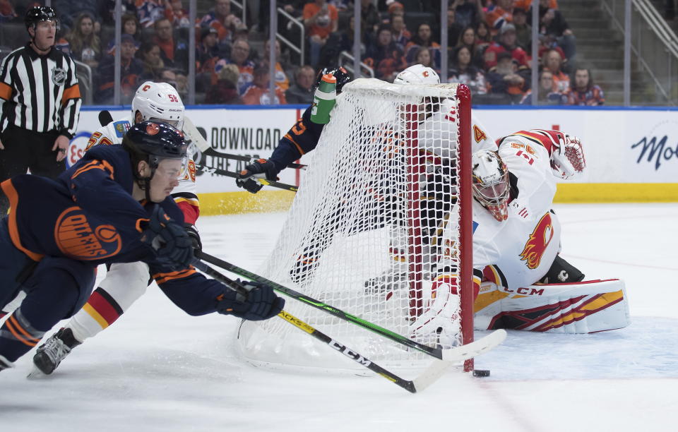 Calgary Flames goalie David Rittich, right, of the Czech Republic, stops Edmonton Oilers' Joakim Nygard, of Sweden, during the second period of an NHL hockey game Friday, Dec. 27, 2019, in Edmonton, Alberta. (Darryl Dyck/The Canadian Press via AP)