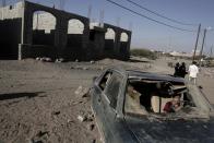 <p>In this Feb. 10, 2018 photo, a boy sits in a damaged car in Mocha, Yemen. (Photo: Nariman El-Mofty/AP) </p>