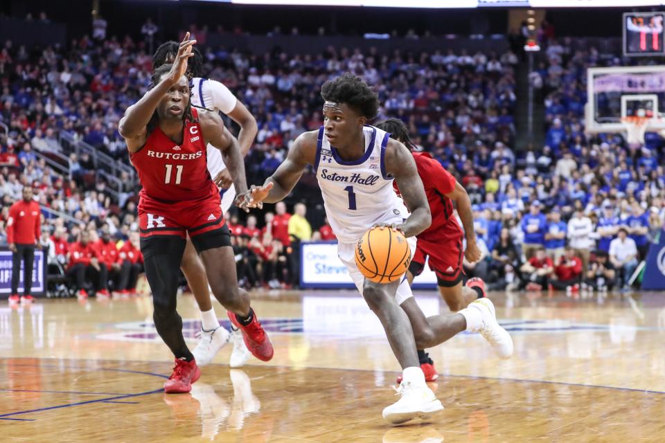 Dec 9, 2023; Newark, New Jersey, USA; Seton Hall Pirates guard Kadary Richmond (1) looks to drive past Rutgers Scarlet Knights center Clifford Omoruyi (11) in the second half at Prudential Center.