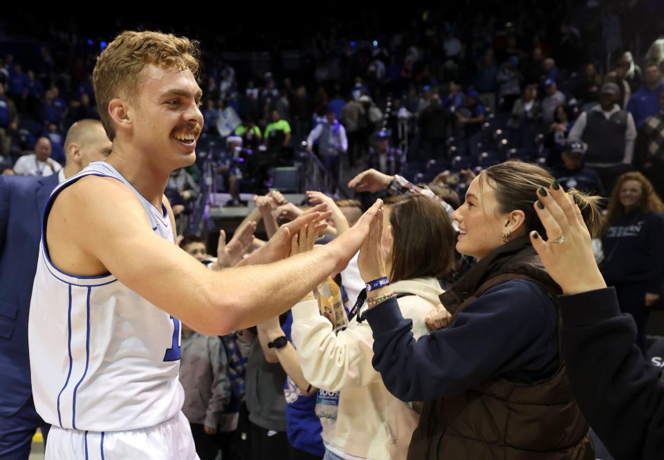 Brigham Young Cougars forward Townsend Tripple (12) high-fives supporters after BYU beat Bellarmine in a men’s basketball game at the Marriott Center in Provo on Friday, Dec. 22, 2023. BYU won 101-59. | Kristin Murphy, Deseret News