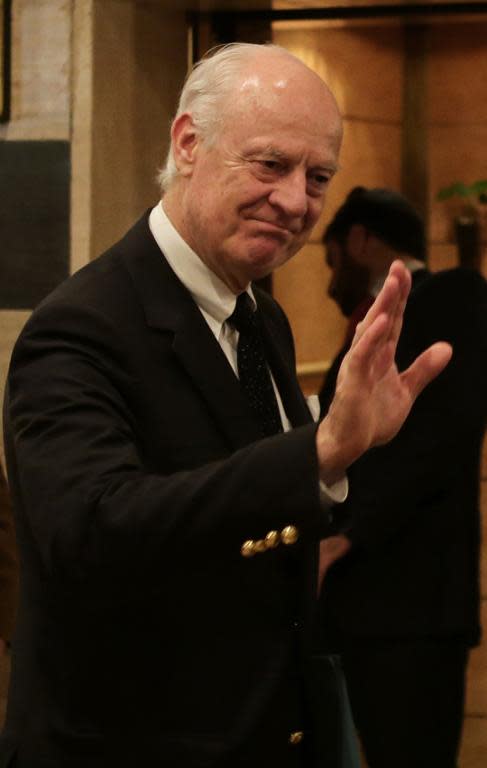 UN special envoy Staffan de Mistura waves to reporters ahead of his meeting with Syrian Deputy Foreign Minister Faisal Moqdad (unseen) in Damascus, on February 28, 2015