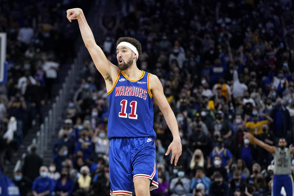 Golden State Warriors guard Klay Thompson (11) reacts after shooting a 3-point basket against the Brooklyn Nets during an NBA basketball game in San Francisco, Saturday, Jan. 29, 2022. (AP Photo/Jeff Chiu)