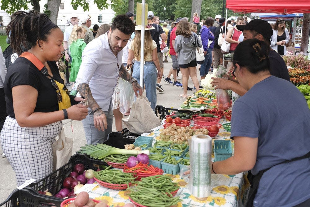 "Top Chef: Wisconsin" contestants Amanda and Kévin shop for ingredients at the Dane County Farmers Market for Episode 5's Quickfire Challenge.