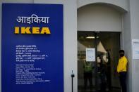 Private security guards stand at the entrance of IKEA's first city store in Mumbai,