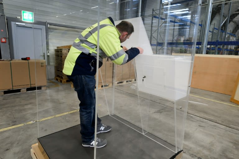 A man assembles transparent voting booths ordered by FIFA presidential contender Prince Ali bin al-Hussein in Zurich on February 24, 2016