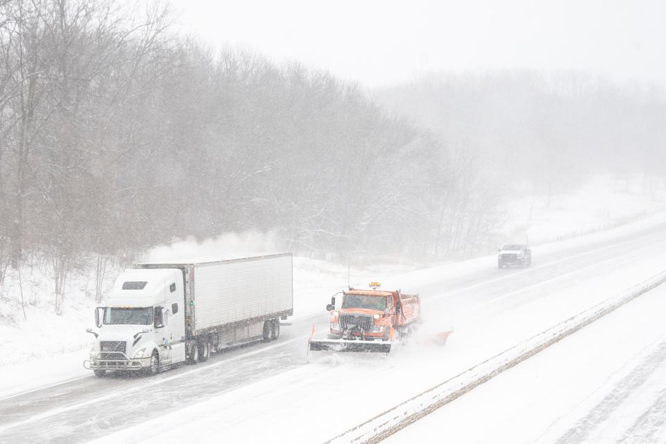 A truck passes an Iowa Department of Transportation plow on Interstate 80 in Iowa City.