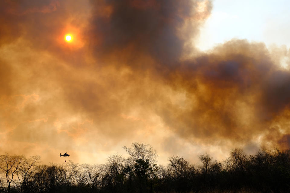 A helicopter flies over Santa Cruz, where there are big forest fires on Aug. 24, 2019. (Photo: Adolfo Lino/EFE via ZUMA Press)