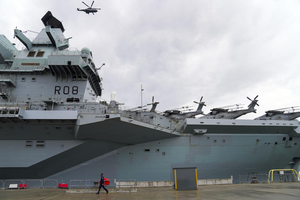 A Royal Navy Merlin helicopter lands on to HMS Queen Elizabeth at HM Naval Base, Portsmouth, ahead of the ship's maiden deployment to lead the UK Carrier Strike Group on a 28-week operational deployment travelling over 26,000 nautical miles from the Mediterranean to the Philippine Sea. Picture date: Saturday May 22, 2021. (Photo by Steve Parsons/PA Images via Getty Images)