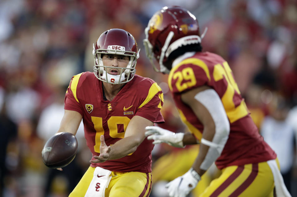 Southern California quarterback Matt Fink (19) pitches to running back Vavae Malepeai (29) during the first half of an NCAA college football game against Utah on Friday, Sept. 20, 2019, in Los Angeles. (AP Photo/Marcio Jose Sanchez)