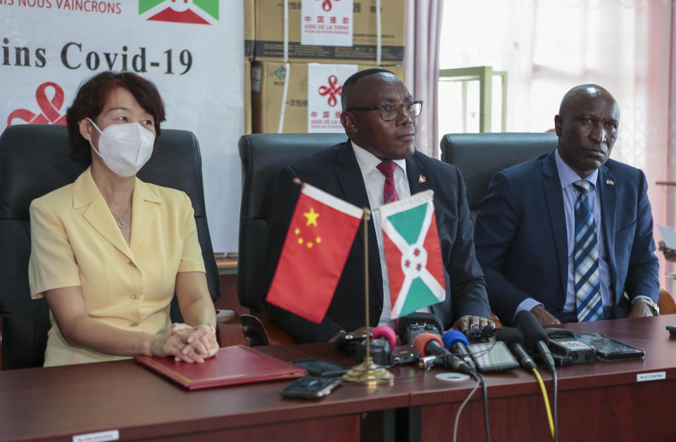 Burundi's Minister of Health Dr Thaddee Ndikumana, center, Minister of Interior Gervais Ndirakobuca, right, and China's ambassador to Burundi Zhao Jiangping, left, attend a ceremony to mark the arrival of the first COVID-19 vaccines to the country, in Bujumbura, Burundi Thursday, Oct. 14, 2021. The arrival of the shipment of Sinopharm vaccine from China marked the end of the country's status as one of the last few in the world to have adopted coronavirus vaccines. (AP Photo/Berthier Mugiraneza)