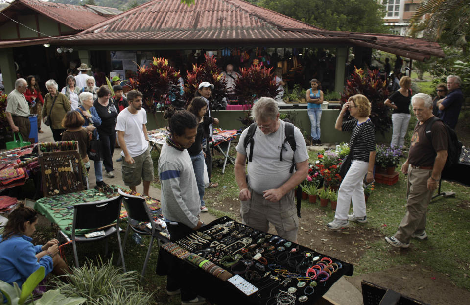 This May 28, 2013 photo shows people gathering at a market in Boquete west of Panama City, Fla. Panama has become a hot spot for American retirees. They come for the natural beauty, the weather and, perhaps more important, the low cost of living. (AP Photo/Arnulfo Franco)