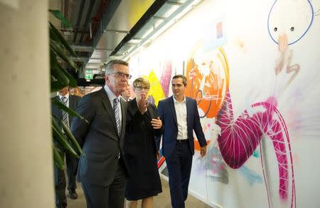 (L-R) German Interior Minister Thomas de Maiziere, Eva- Maria Kirschsieper, Facebook head of public policy D-A-CH and Martin Ott, Facebook managing director central Europe, walk during a vistit at the Facebook office in Berlin, Germany August 29, 2016. REUTERS/Stefanie Loos