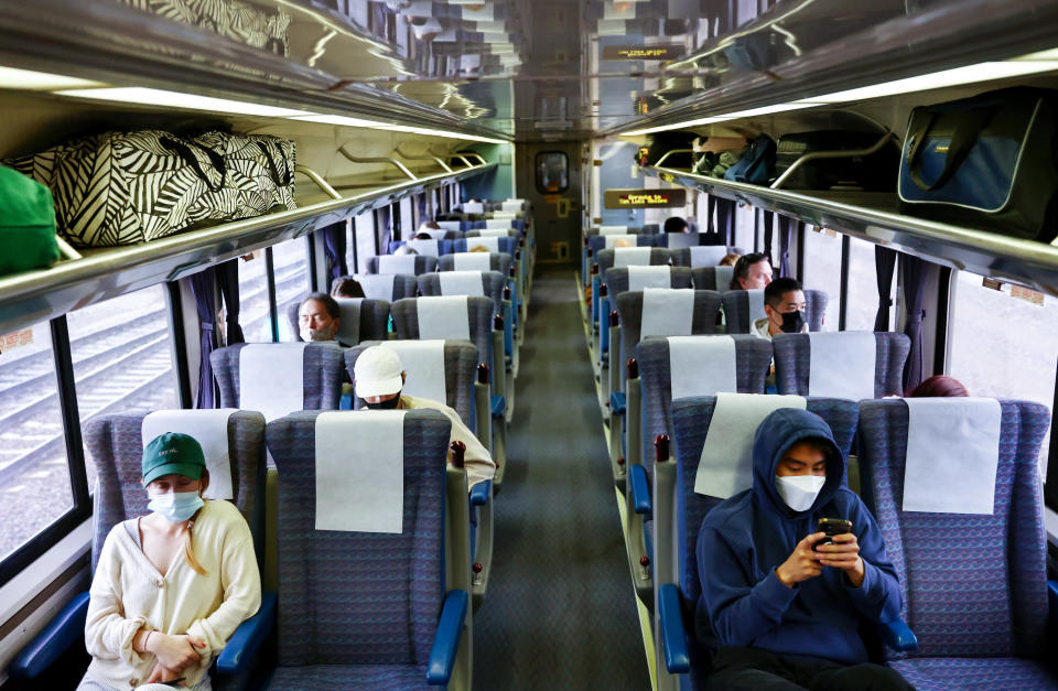 A handful of passengers ride a passenger train