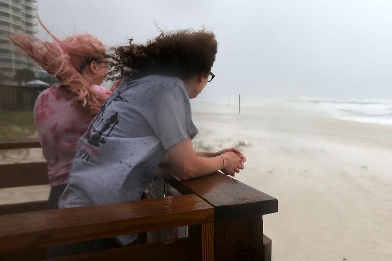 Jordan Spence and Dawson Stallworth watch waves come ashore as Hurricane Sally approaches in Orange Beach