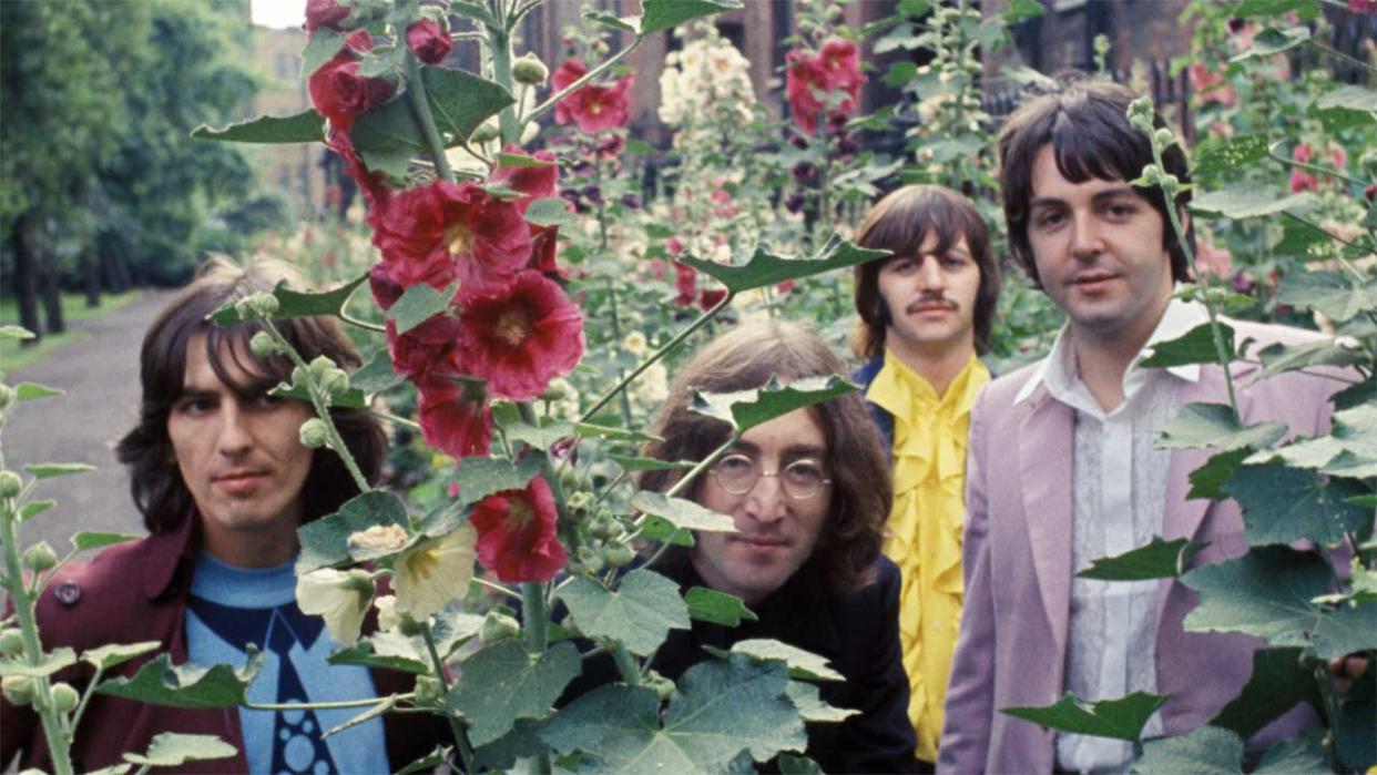  The Beatles surrounded by flowers. 