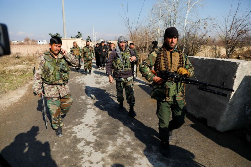 Afghan security forces arrive near the site of a suicide attack in Bagram, north of Kabul, Afghanistan