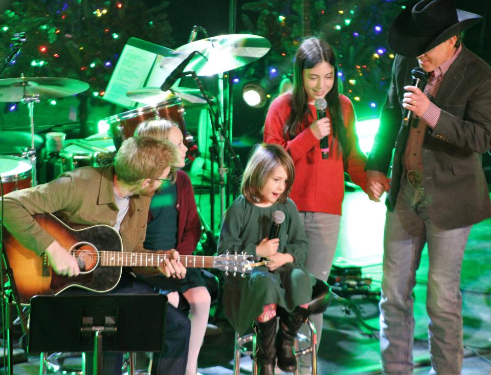 Twila Clarke, center, daughter of guitar player Bryce Clark, led the group in "Rudolph the Red-Nosed Reindeer" during Thursday's Aaron Watson Family Christmas Show at the Paramount Theatre. To her right is her sister, Acuff Rose, while Watson was joined by his daughter, Jolee Kate