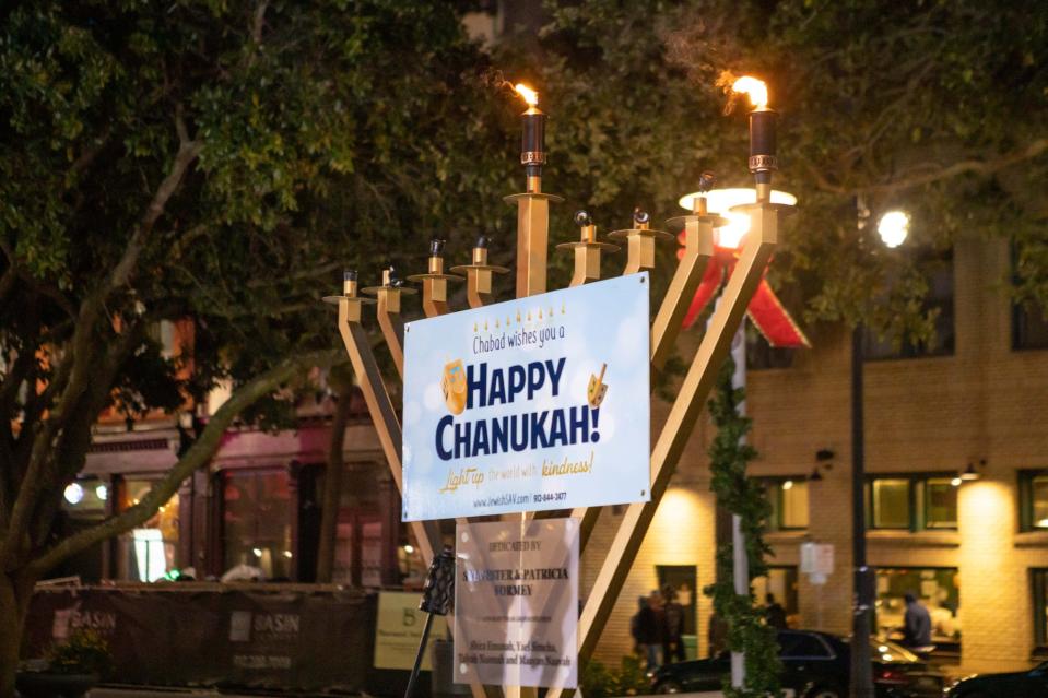 Chabad of Savannah begins the celebration of Hanukkah by lighting the first candle on the menorah in Ellis Square.