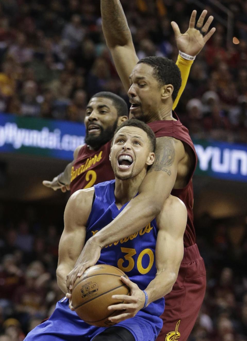 From foreground, Golden State Warriors' Stephen Curry is fouled by Cleveland Cavaliers' Channing Frye as Kyrie Irving defends in the second half of an NBA basketball game, Sunday, Dec. 25, 2016, in Cleveland. The Cavaliers won 109-108. (AP Photo/Tony Dejak)