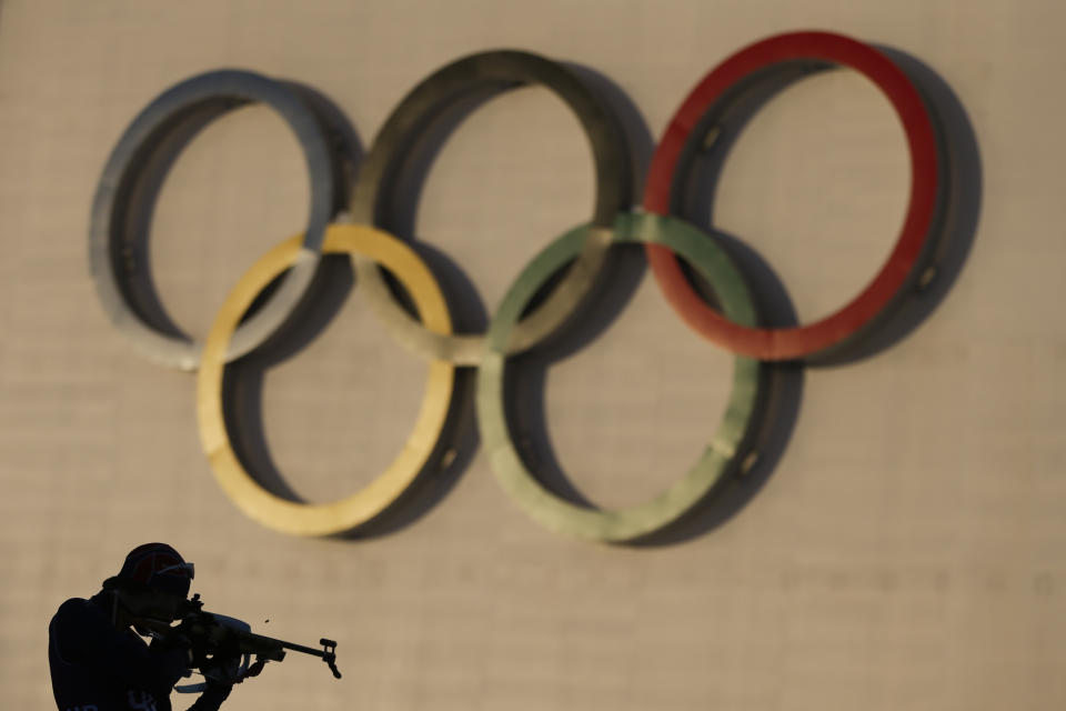 A biathlete trains during sunset at Laura Cross-country Ski & Biathlon Center ahead of the 2014 Winter Olympics, Monday, Feb. 3, 2014, in Krasnaya Polyana, Russia. (AP Photo/Felipe Dana)